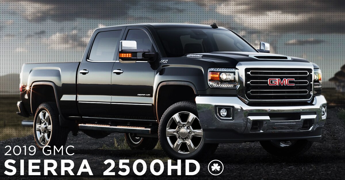 2019 Black GMC Sierra 2500HD parked on a gravel road in the open field