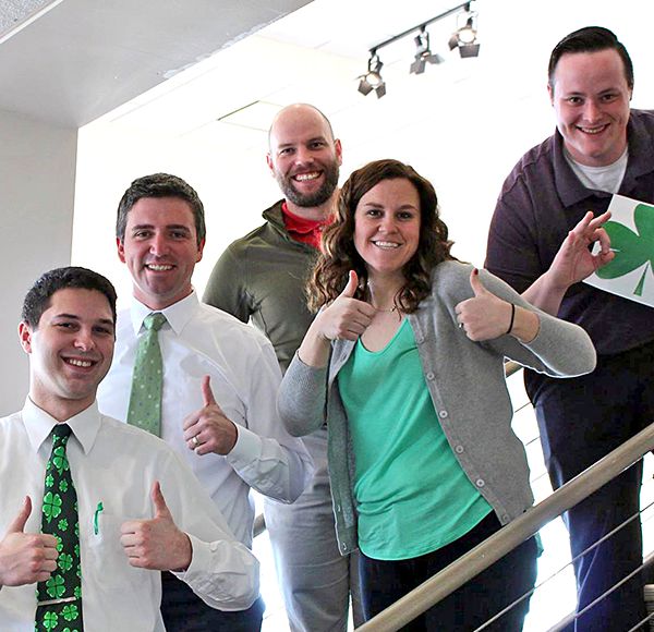 McGrath staff standing on stairway smiling
