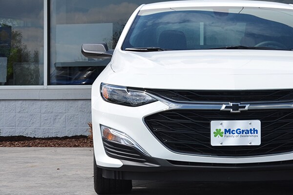 2019 white Chevy Malibu parked front grille and headlights