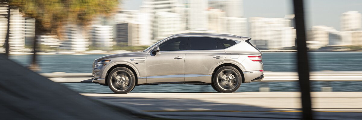 Grey 2021 GV80 Sport trim driving down a winding road
