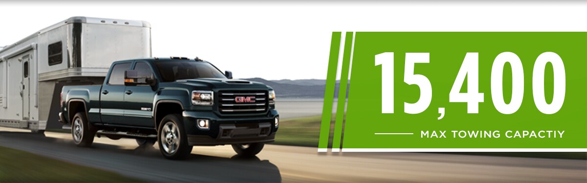 2019 GMC Sierra 2500HD Towing large trailer in the countryside