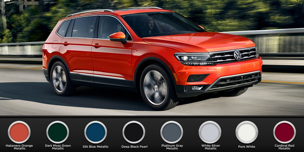 2019 Metallic Orange Volkswagen Tiguan driving down the road with all color schemes available