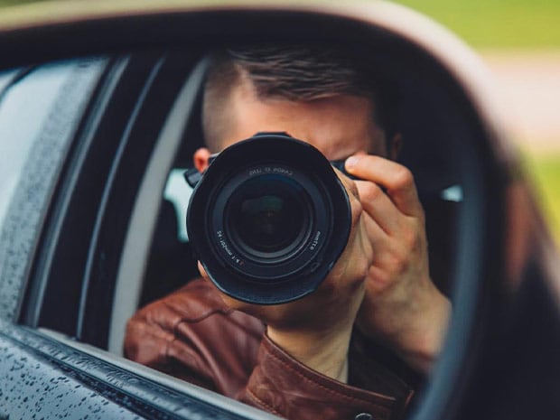 Man in car shooting camera