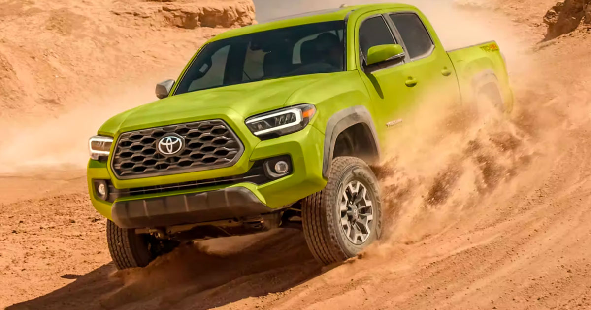 Toyota Tacoma driving down sand dune