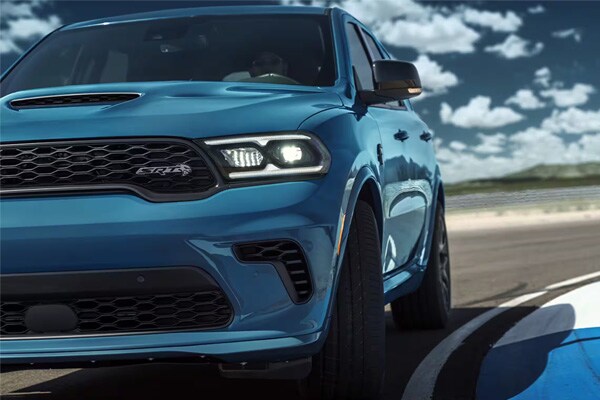 Blue Dodge Durango driving down road