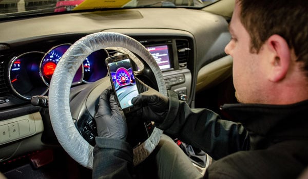 wrapped steering wheel and gloves taking service pictures