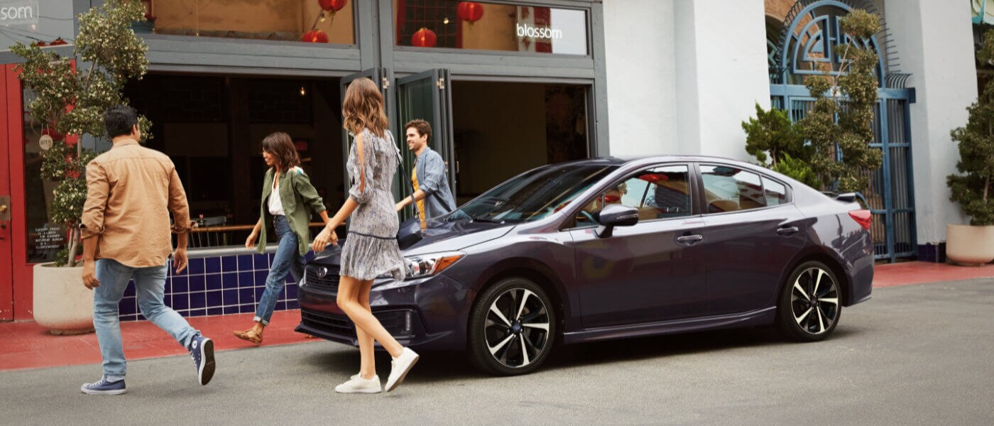 2022 Subaru Impreza parked by restaurant with friends