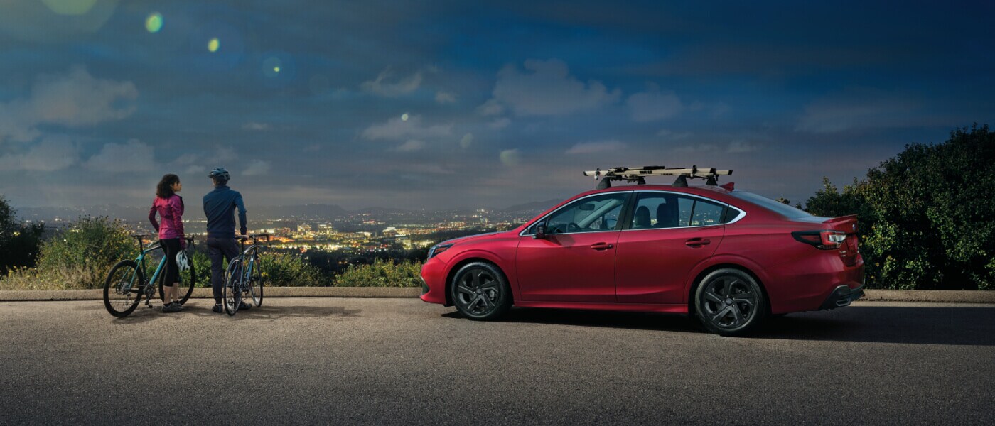 2022 Subaru Legacy parked in front of a city skyline