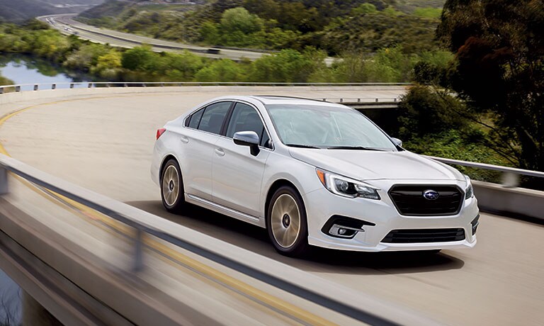 2019 Subaru Legacy White 2019 Subaru Legacy driving down hill