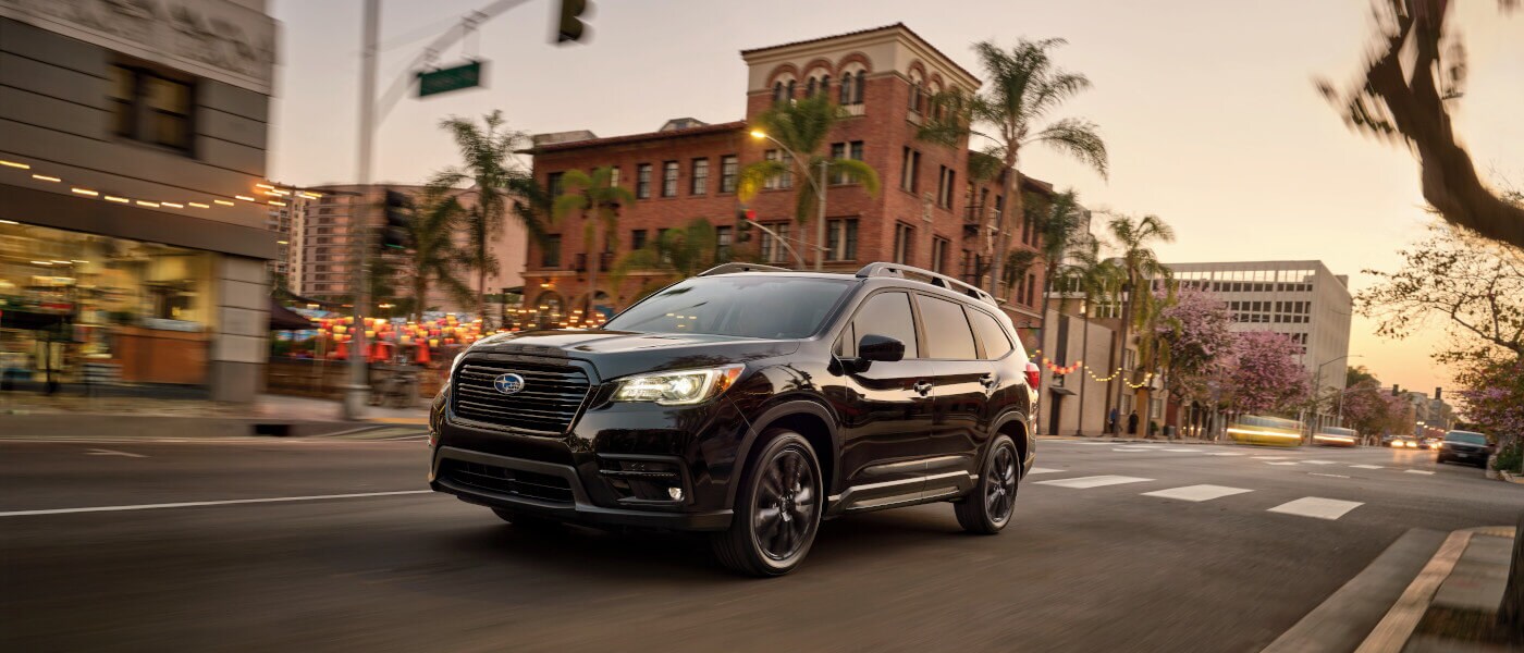 2022 Subaru Ascent driving on a tropical city road