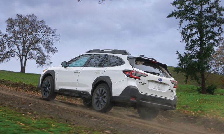 2023 Subaru Outback Exterior Driving Up A Forest Hill