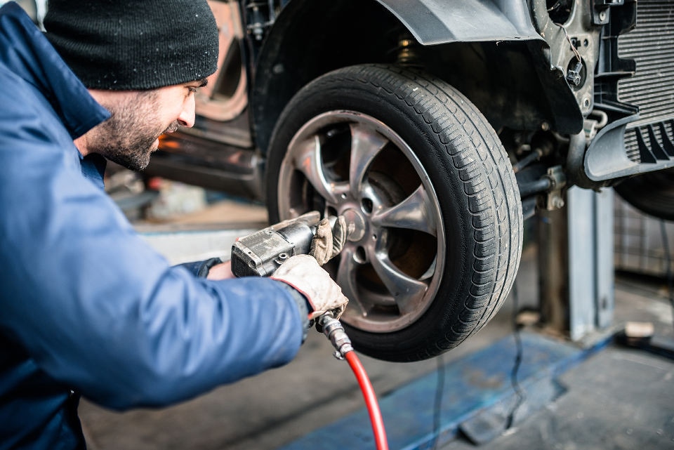 McLaughlin Volvo Service Center A mechanic changing a tire