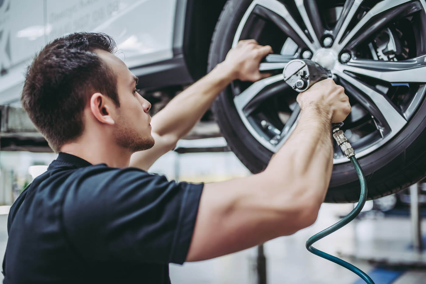 A service team member working on a tire.