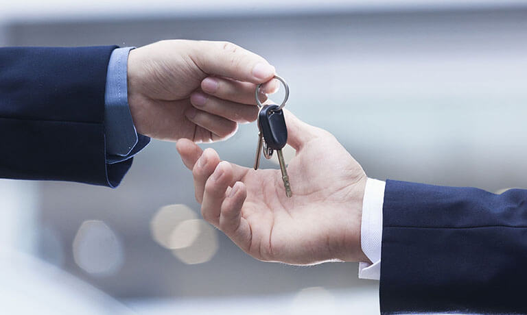 Car keys being handed over