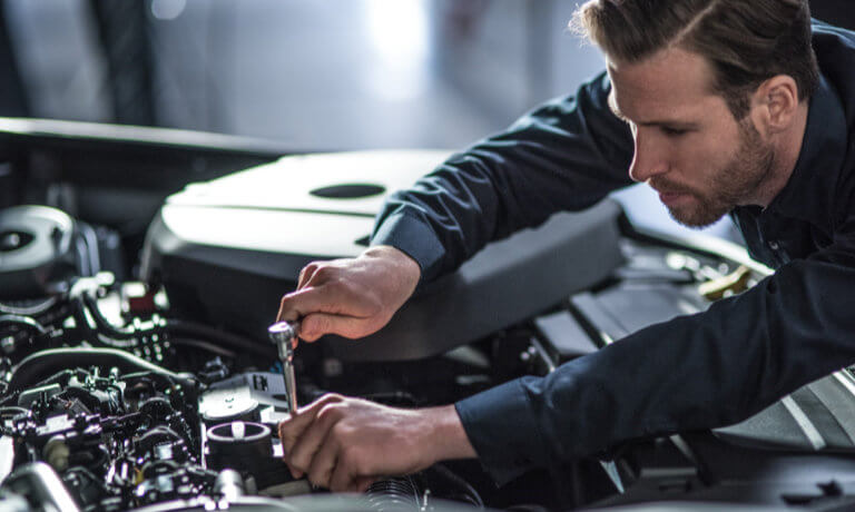 Volvo Service Tech Under Hood