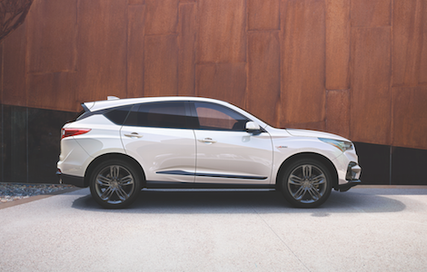 2019 Acura RDX A white 2019 Acura RDX parked infront of a wooden wall