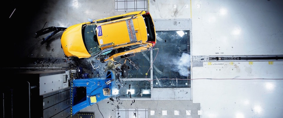 A safety crash test of a yellow Volvo XC60