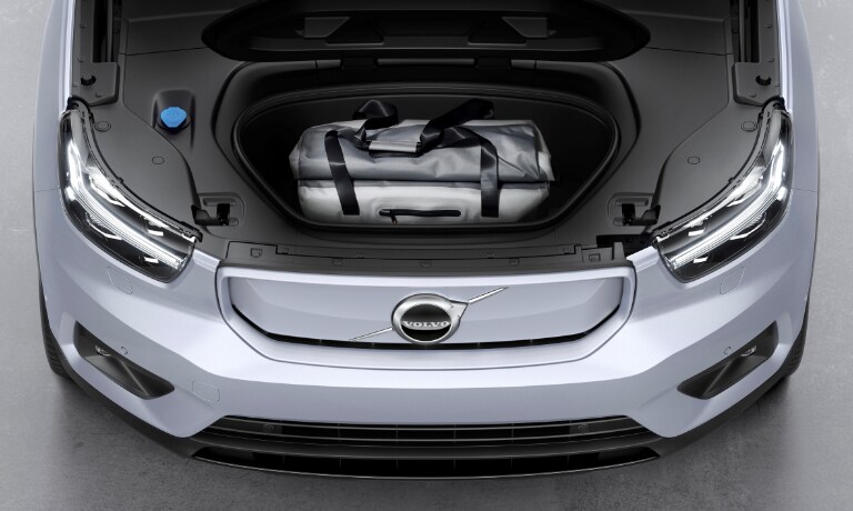 2020 Volvo XC40 Recharge in silver showing the front hood open showing storage space