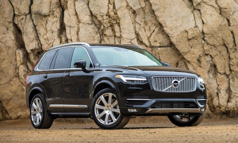 2016 Volvo XC90 parked in front of a rocky cliff