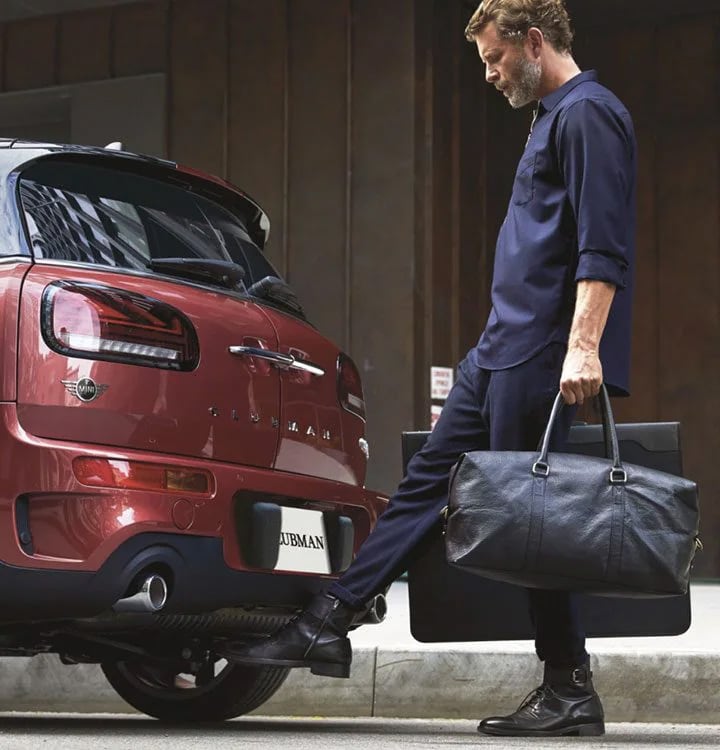 A MINI Clubman owner using the footwave technology to open the car.