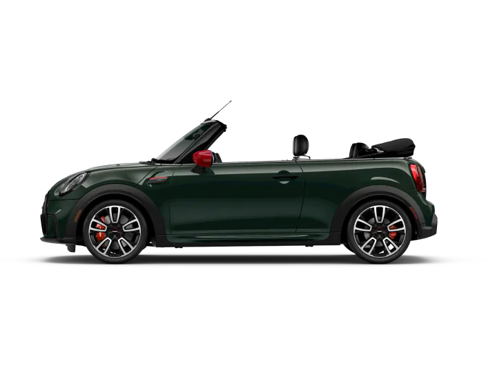 Side view of a dark green MINI Convertible on a white background.