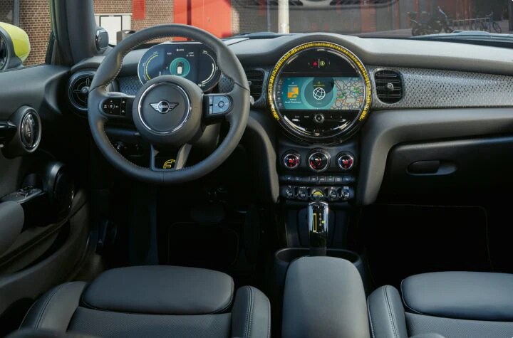 A view of the updated steering wheel, dashboard, and radio of the MINI Cooper SE Hardtop 2 Door.