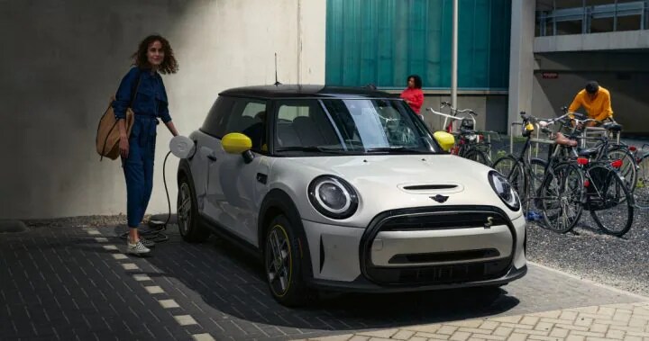 13.2 Alt Text Someone charging their 2022 MINI Electric Hardtop 2 Door while parke.png