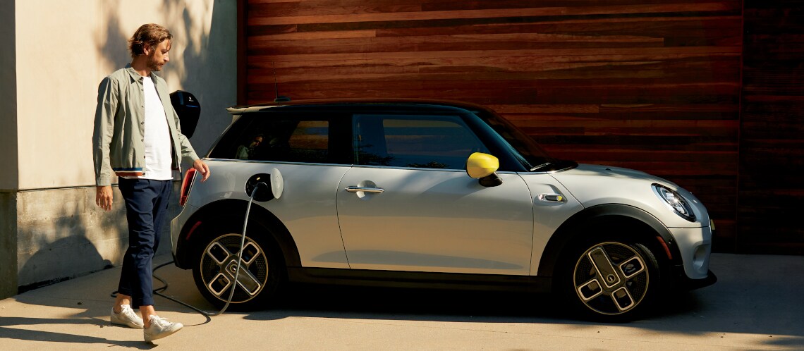 MINI Electric Hardtop 2 Door white silver with yellow trim being charged.jpg