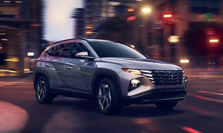 2023 Hyundai Tucson city street at dusk