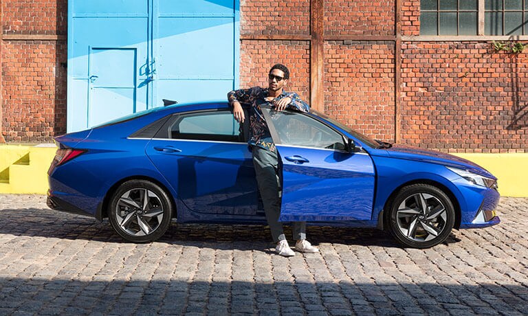 2021 Hyundai Elantra parked with a man leaning against it