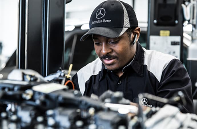 Mercedes-Benz service technician working on a vehicle