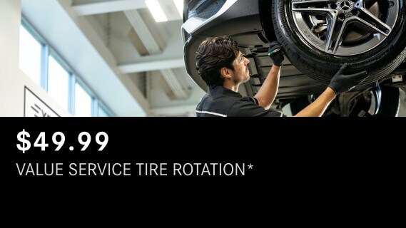 Learn about the Mercedes-Benz Value Service Tire Rotation package Mercedes-Benz Value Service Tire Rotation showing a technician working on a tire on a lifted Mercedes-Benz vehicle