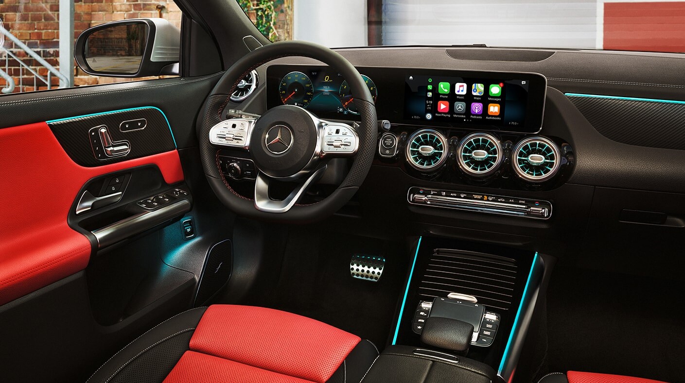 2022-mercedes-benz-gla-4.PNG A view of the red and black upholstered interior and black dash with teal accent lighting on the dash of a 2022 Mercedes-Benz GLA