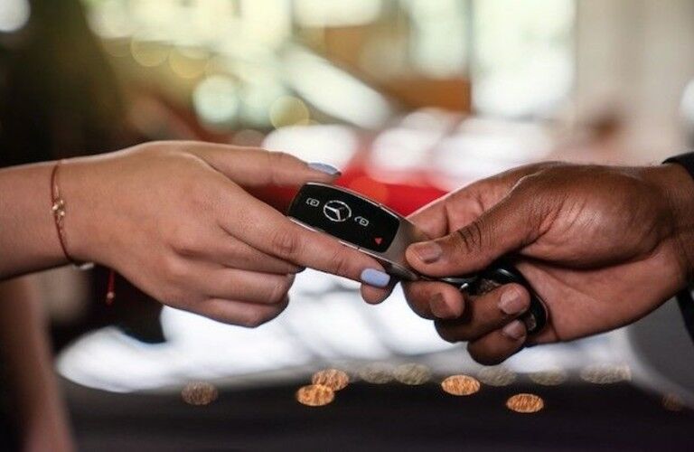 woman_handing_keys_to_mercedes-benz_back_to_sales_associate_at_mb_coral_gables_d.jpg