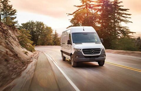 2020_MB_Sprinter_Van_white_exterior_front_passenger_side_driving_on_curvy_road_cliff_on_side_o.jpg