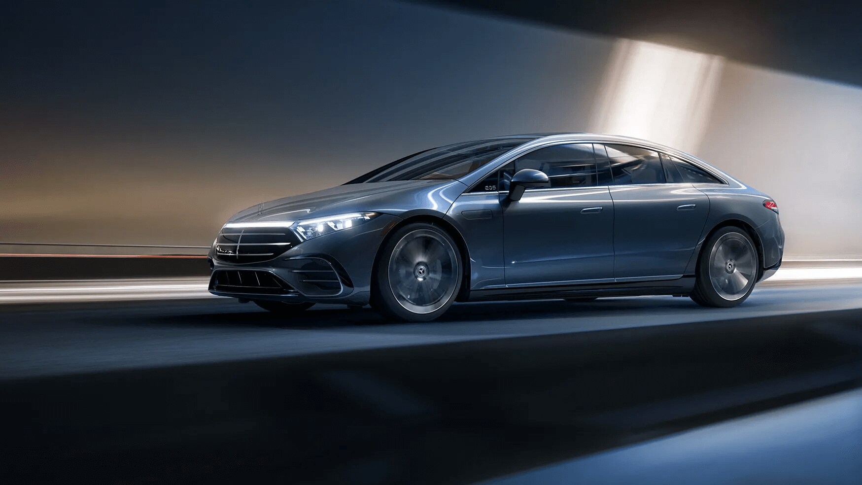 Learn about the specs & features of the 2025 Mercedes-Benz EQS Sedan Rendered image of a Mercedes-Benz EQS Sedan driving down a road