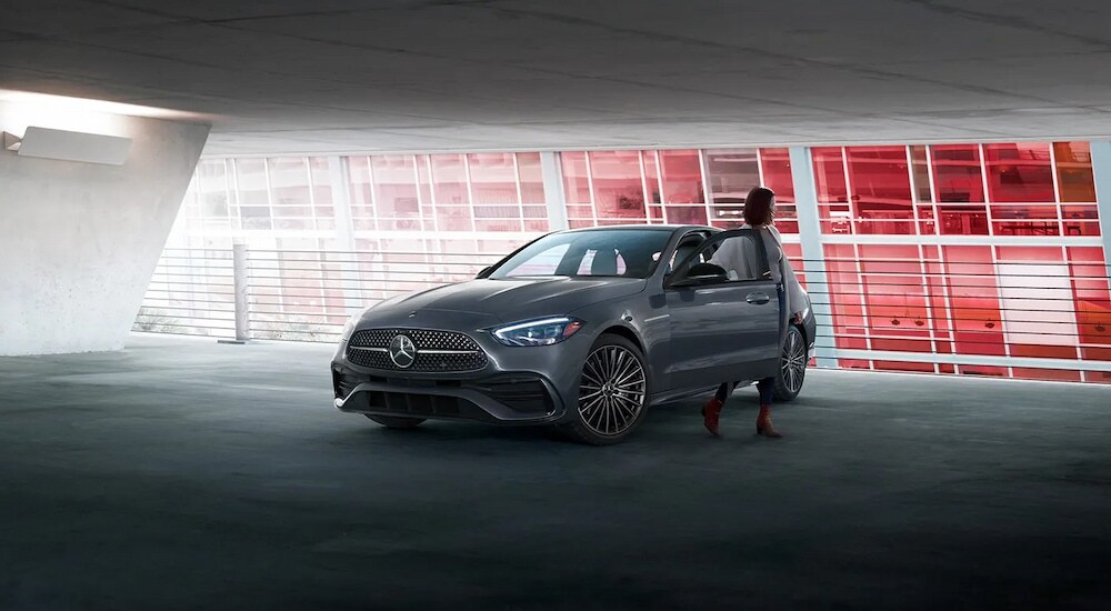 A silver 2024 Mercedes-Benz C 300 Pinnacle parked in a modern garage