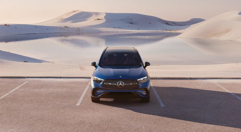 Mercedes-Benz%20GLC%20for%20Sale%20-%202025%20Mercedes-Benz%20GLC%20300%204MATIC%20Pinnacle%20-%20Dunes.jpg A blue 2025 Mercedes-Benz GLC 300 4MATIC Pinnacle parked in front of sand dunes.
