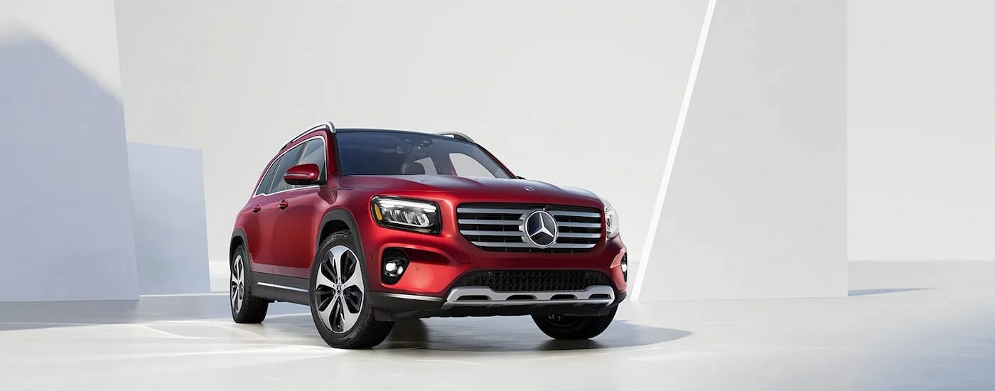 A red 2025 Mercedes-Benz GLB 250 Pinnacle in the showroom of a Mercedes-Benz dealer near Redding.