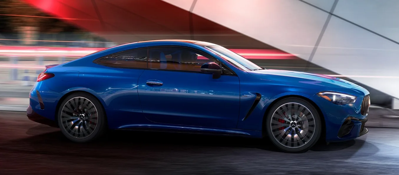 Blue AMG CLE Coupe driving past streaks of light