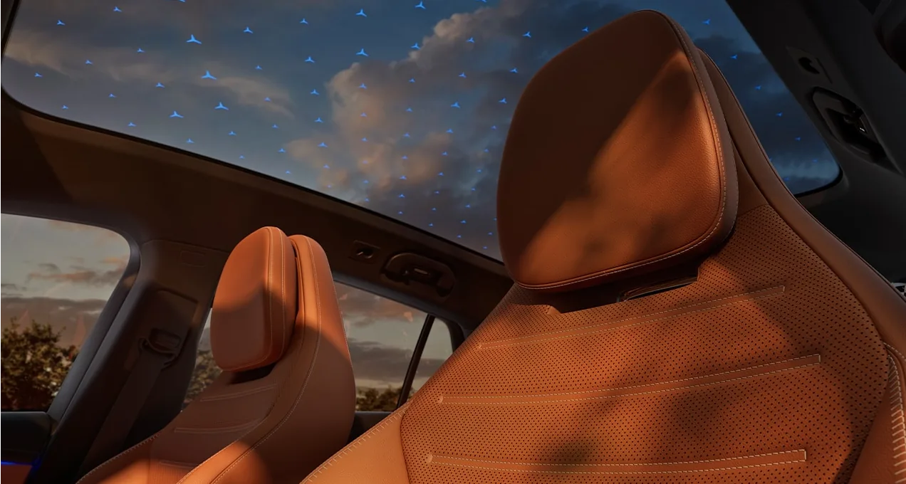 Tan leather front seats under a starlit Panorama roof