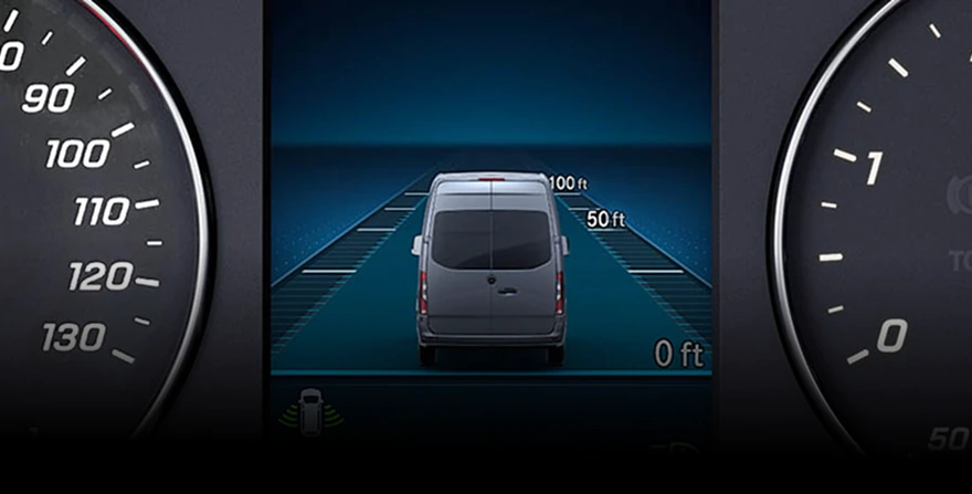 Instrument cluster display showing Active Distance Assist Distronic tracking a van ahead with 50 ft and 100 ft distance markers
