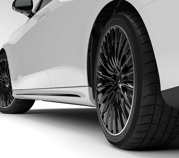 Close-up of a black multi-spoke wheel on a white E-Class