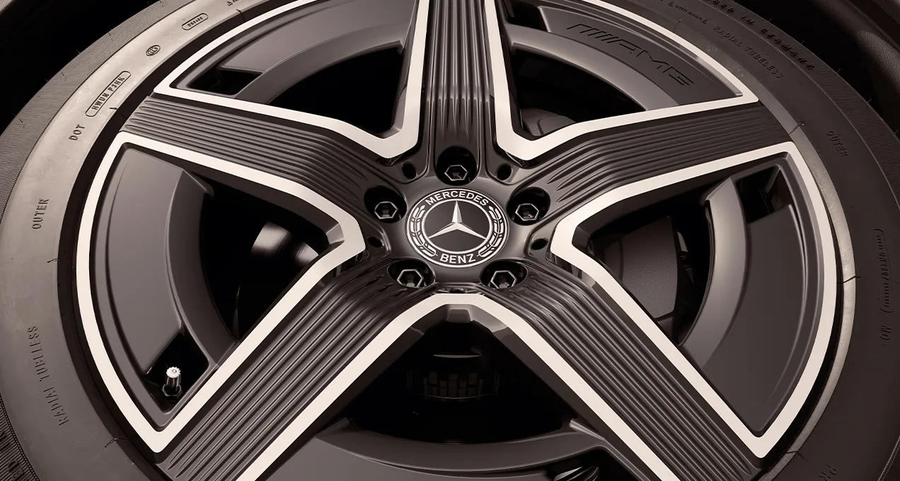 Close-up of a black-accented 5-spoke 19-inch AMG wheel on the GLC