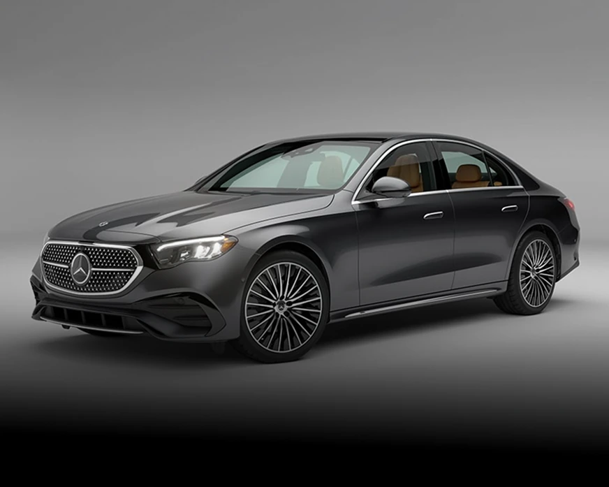Dark grey E-Class Sedan in a softly lit studio