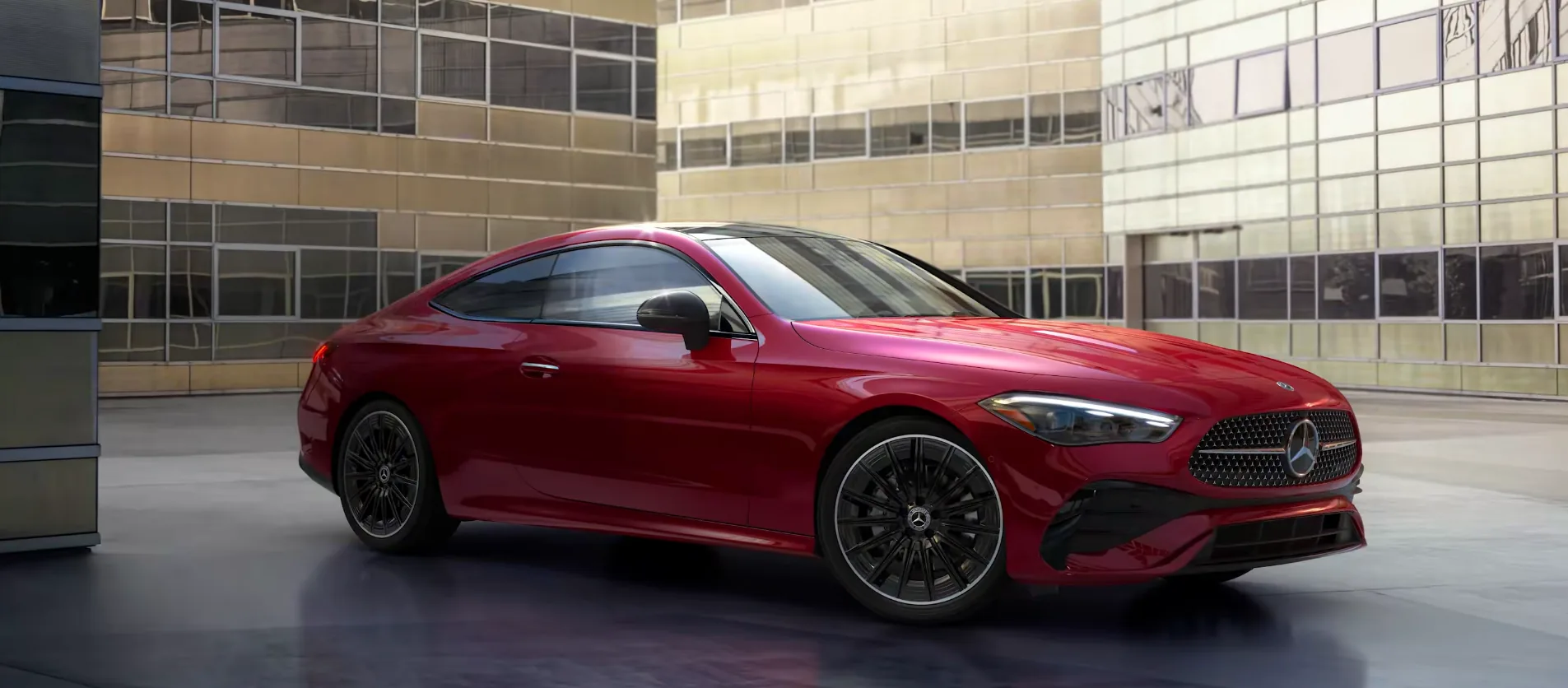 Red CLE Coupe parked in front of a glass office building