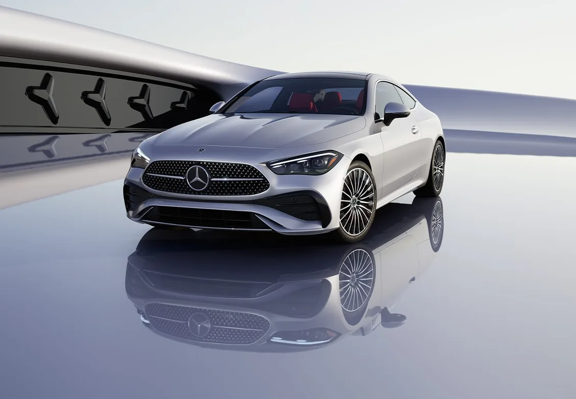 Silver CLE Coupe with AMG Line styling reflected on a glossy studio floor