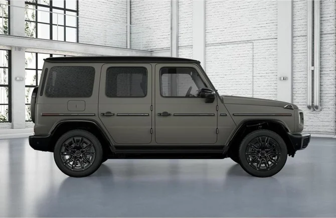 An olive green Mercedes-Benz G-Class shown in profile in a bright studio