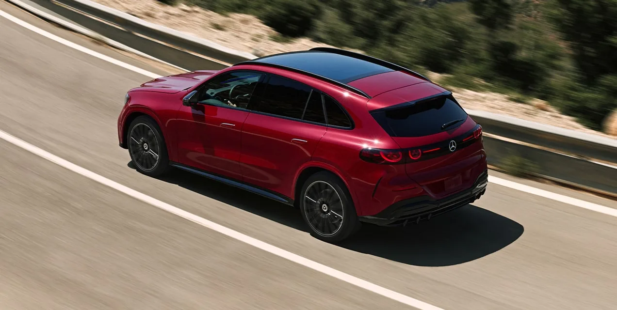 Red GLC Electric SUV driving along a winding hillside road
