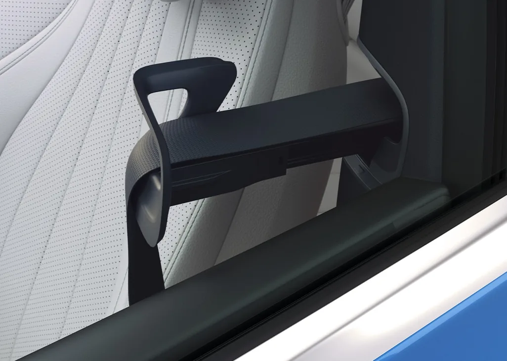 CLE automatic seat belt presenter extending beside a white front seat